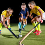 Field hockey female players struggle for the ball