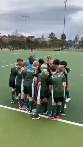 Greensborough Hockey Club Under 12 Mixed team in a pre-match huddle during the 2026 grand final